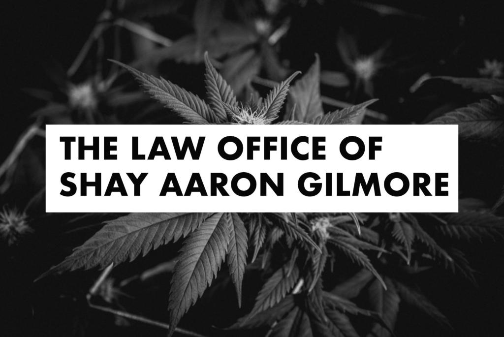 Black-and-white photo of cannabis leaves with a white rectangle overlaid. Inside the rectangle, bold uppercase text reads, "THE LAW OFFICE OF SHAY AARON GILMORE," highlighting Shay Aaron Gilmore’s expertise. CA Norml