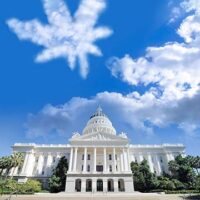 Image of a large white government building with a dome, set against a blue sky with some clouds. A cloud shaped like a marijuana leaf is prominently featured above the building. The bottom of the image includes the text "California NORML" and "www.CaNORML.org," highlighting Cal NORML opposes AB 243. CA Norml