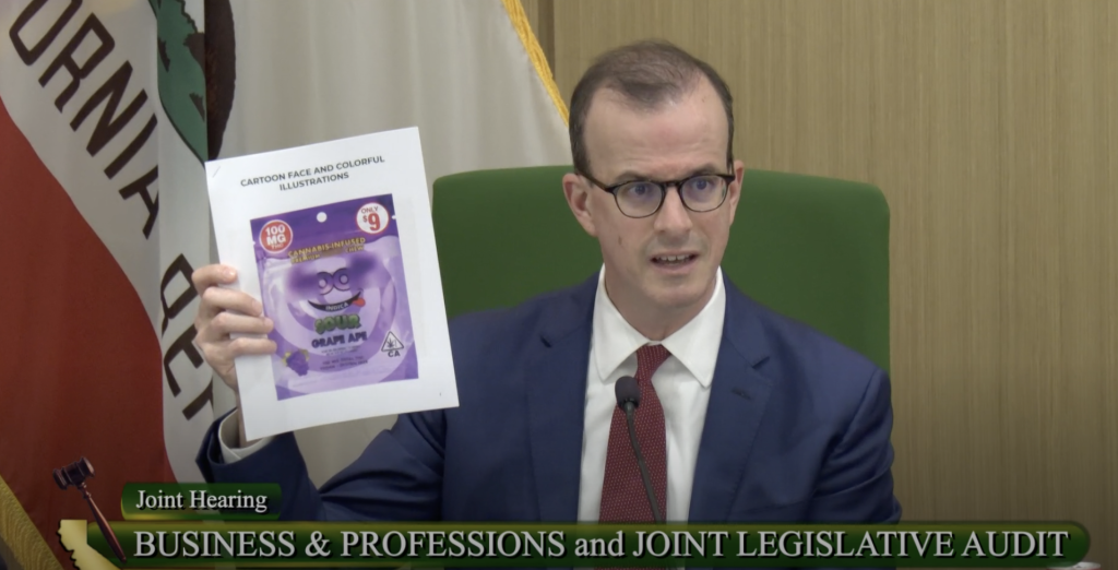 Asm. Berman holds up a cannabis package he called, "straight out of Alice in Wonderland"