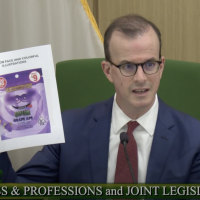 Asm. Berman holds up a cannabis package he called, "straight out of Alice in Wonderland"