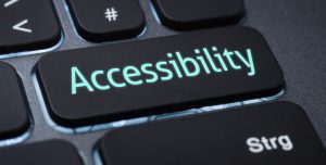 A close-up of a keyboard with a large black key labeled “Accessibility” in glowing blue letters, highlighting the importance of ADA compliance for any cannabis website. Ca NORML
